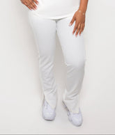 A person standing against a white background, wearing ivory drawstring scrub pants..