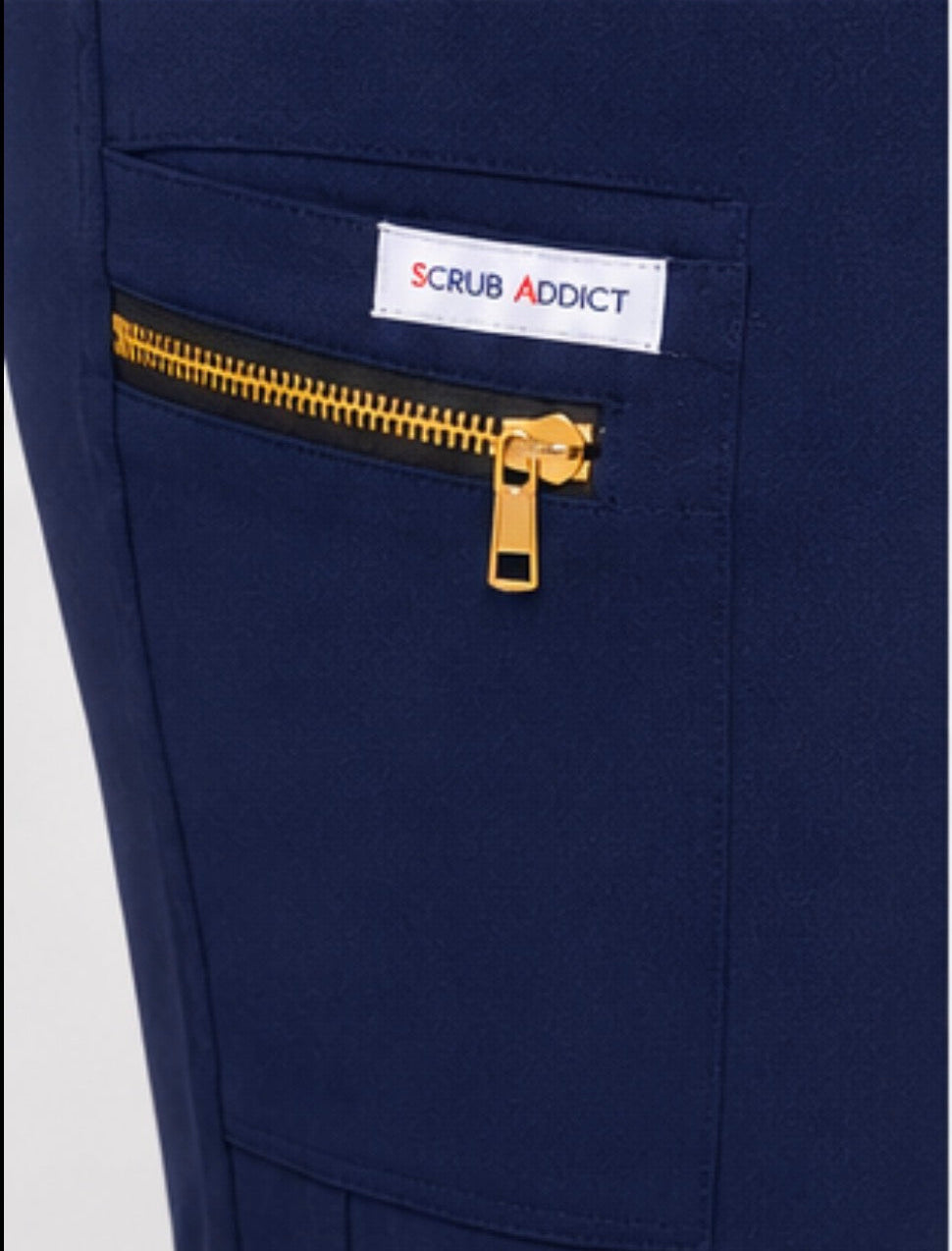 Navy blue scrub pants with a gold zipper and 'Scrub Addict' label on a white background