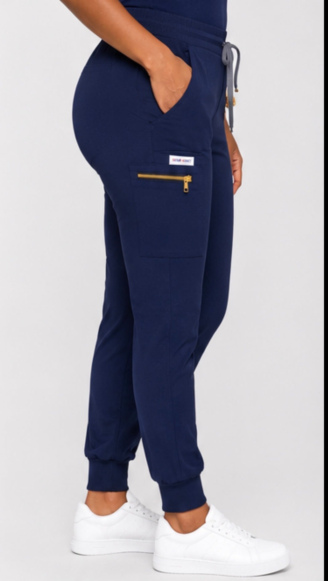 Navy blue jogger pants with a key pocket detail on a white background